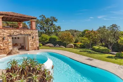 a pool in the backyard of a home with a gazebo at Villa Domaine de Pinarello in Pinarellu
