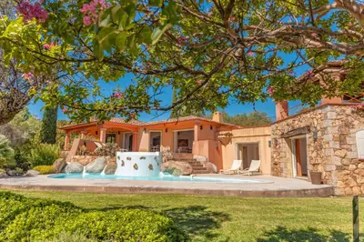 a villa with a swimming pool and a house at Villa Domaine de Pinarello in Pinarellu