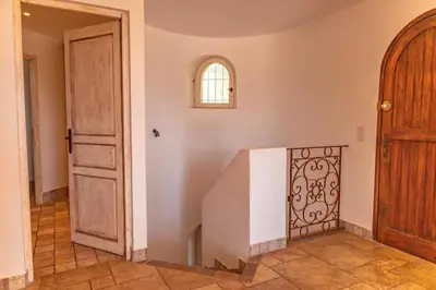 a room with a staircase with a door and a window at Villa Domaine de Pinarello in Pinarellu