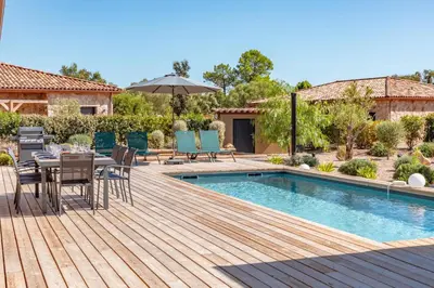a deck with a table and chairs next to a pool at Villa Felicita di Lecci in Lecci