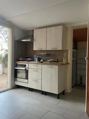 a kitchen with white cabinets and a stove at Studio Smart&Cosy in Porto-Vecchio