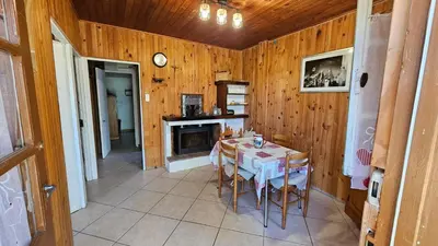 a dining room with a table and a fireplace at CHALET BAVEDDA- Accès chemins de randonnée- Calme - Montagne in Quenza