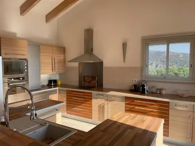 a kitchen with wooden cabinets and a sink at House with sea view, Route de Palombaggia in Porto-Vecchio