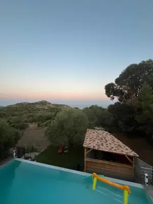 a view of a swimming pool with a building at House with sea view, Route de Palombaggia in Porto-Vecchio