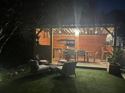 a patio with chairs and a table in a yard at House with sea view, Route de Palombaggia in Porto-Vecchio