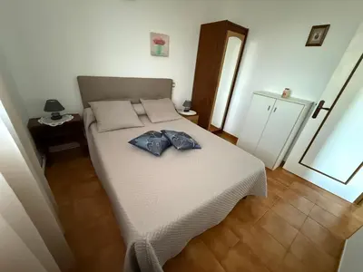 a bedroom with a bed with two shirts on it at chez Ange et Maryse à Olmeta di tuda in Olmeta-di-Tuda