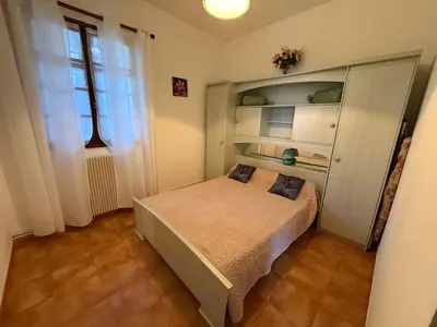 a small bedroom with a bed and a window at chez Ange et Maryse à Olmeta di tuda in Olmeta-di-Tuda