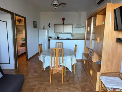 a kitchen and dining room with a table and chairs at chez Ange et Maryse à Olmeta di tuda in Olmeta-di-Tuda