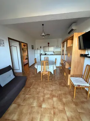 a living room with a table and a couch at chez Ange et Maryse à Olmeta di tuda in Olmeta-di-Tuda