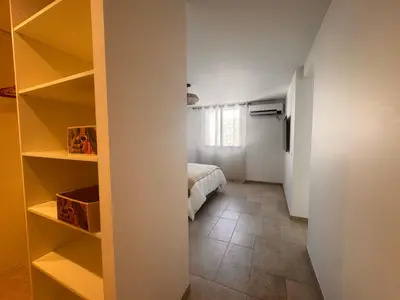 a room with a bed and a room with shelves at Superbe Villa Arià avec piscine chauffée in Calenzana