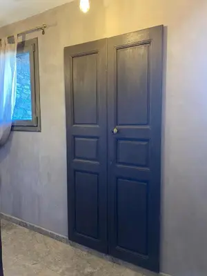 a blue door in a room with a window at U Casellu in Oletta