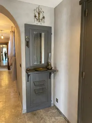 a bathroom with a gray cabinet with a mirror at U Casellu in Oletta