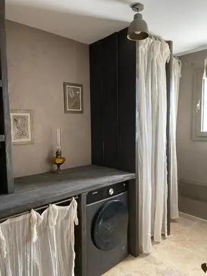 a laundry room with a washer and dryer at U Casellu in Oletta