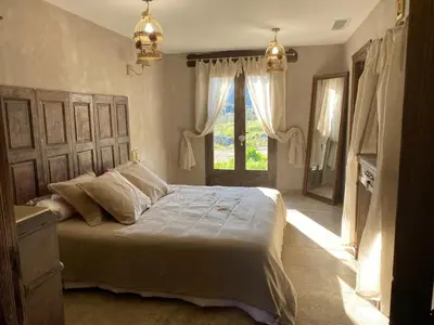 a bedroom with a large bed and a window at U Casellu in Oletta