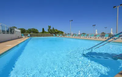 a large swimming pool with blue water at Villa Moderne Plage À Pieds in Prunete