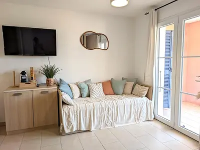 a living room with a couch and a tv at Apartment at Solenzara Marina in Sari Solenzara
