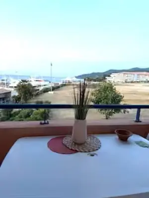 a vase sitting on a table on a window sill at Apartment at Solenzara Marina in Sari Solenzara