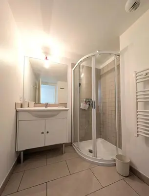a bathroom with a glass shower and a sink at Apartment at Solenzara Marina in Sari Solenzara