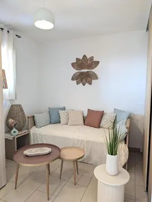 a living room with a couch and two tables at Apartment at Solenzara Marina in Sari Solenzara