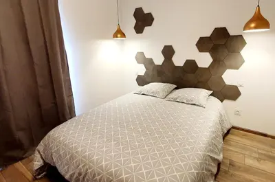 a bedroom with a bed with a headboard at Appartement neuf avec extérieur de plein pieds in Levie
