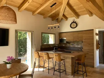 a kitchen with a wooden counter and a table and chairs at charmante bergerie in Bonifacio