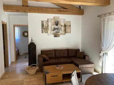 a living room with a couch and a statue on the wall at charmante bergerie in Bonifacio