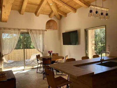 a kitchen and dining room with a table and chairs at charmante bergerie in Bonifacio