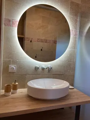 a bathroom with a sink and a mirror at charmante bergerie in Bonifacio