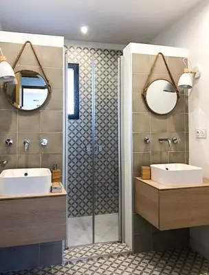 a bathroom with two sinks and a shower with two mirrors at Villa With Views Over Gulf Of Ajaccio in Coti-Chiavari
