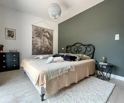 a bedroom with a large bed and a rug at Villa With Views Over Gulf Of Ajaccio in Coti-Chiavari