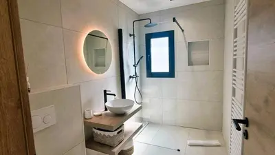 a bathroom with a sink and a shower in it at Villa Juca, 10 pers, piscine chauffée, 10 minutes plage in Cirendinu