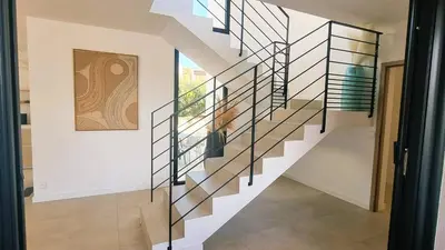 a staircase in a house with glass railings at Villa Juca, 10 pers, piscine chauffée, 10 minutes plage in Cirendinu
