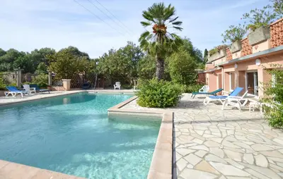 a swimming pool with chairs and a palm tree at Stunning Home In Querciolo in Venzolasca