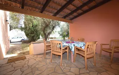 a dining table and chairs on a patio at Stunning Home In Querciolo in Venzolasca