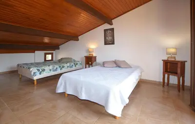 a bedroom with a bed and two night stands at Stunning Home In Querciolo in Venzolasca