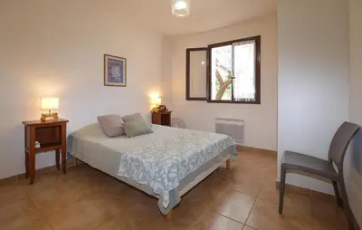 a bedroom with a bed and a window and a chair at Stunning Home In Querciolo in Venzolasca