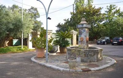a fountain in the middle of a street with plants at Stunning Home In Querciolo in Venzolasca
