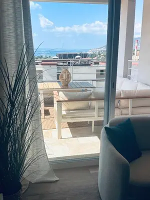 a living room with a view of a balcony at Bleu Corse, entre mer et soleil in Ajaccio