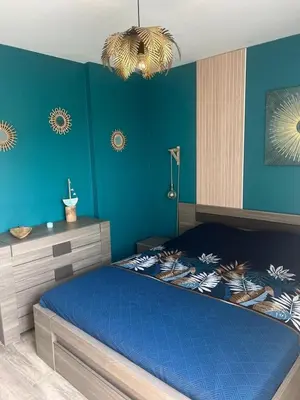 a bedroom with blue walls and a blue bed at Bleu Corse, entre mer et soleil in Ajaccio