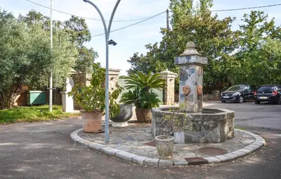 a fountain in the middle of a parking lot at Appartement Residence Piscine in Venzolasca