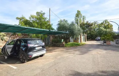 a small car with its door open in a driveway at Appartement Residence Piscine in Venzolasca