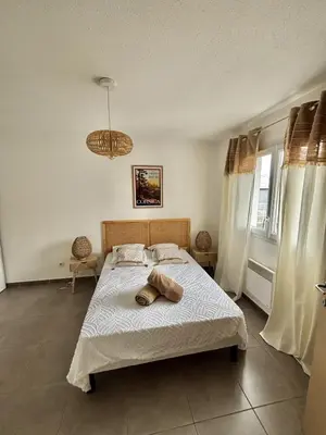 a bedroom with a bed with two towels on it at Maison Dolce Vita in Ghisonaccia