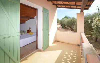 an open door to a bedroom with a bed and a window at Maison Residence Piscine in Venzolasca