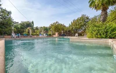 a swimming pool with blue water in a yard at Maison Residence Piscine in Venzolasca