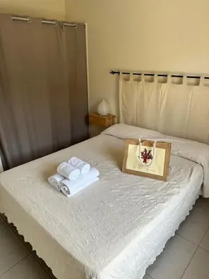 a bed with two towels and a tray on it at T3 - bord de mer - piscine - vue magnifique in Propriano