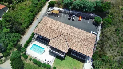 an overhead view of a house with a swimming pool at T3 - bord de mer - piscine - vue magnifique in Propriano