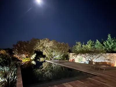 a wooden walkway in a park at night at VILLA Corse du Sud in Pianottoli-Caldarello