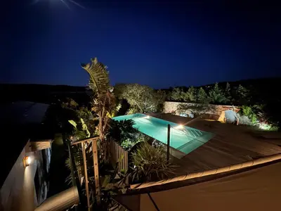 a swimming pool at night on a house at VILLA Corse du Sud in Pianottoli-Caldarello