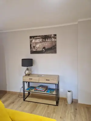 a living room with a table and a van on the wall at appartement vezzani in Vezzani