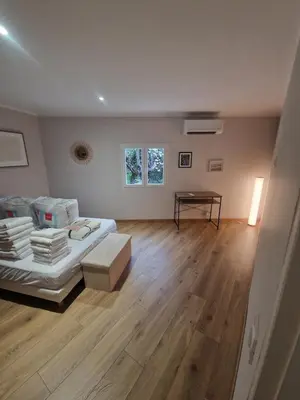 a bedroom with a bed and a table in it at appartement vezzani in Vezzani